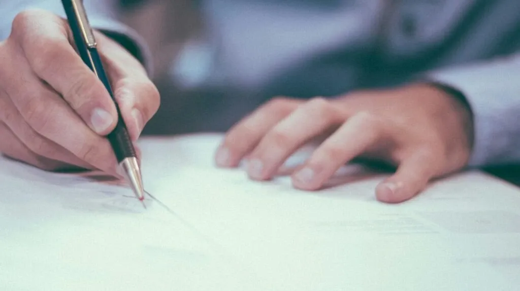 Man signing document